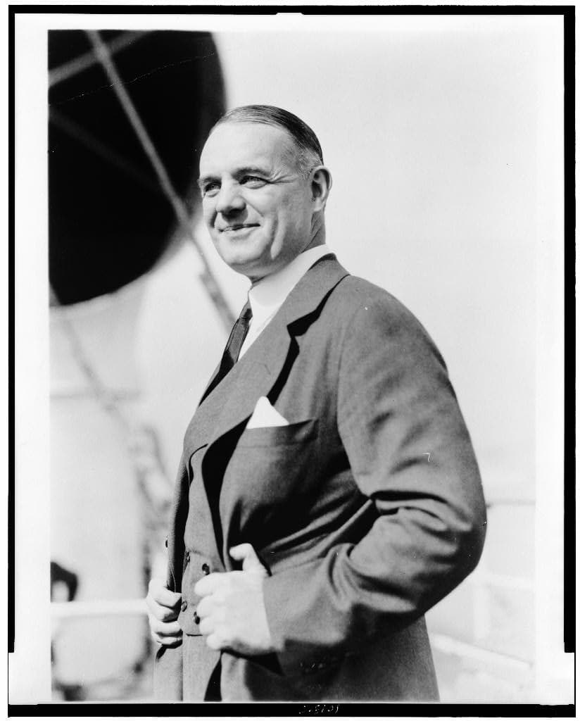 William J. Donovan, half-length portrait, standing, facing left